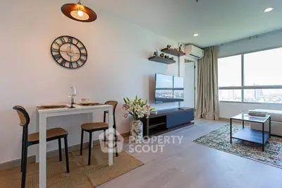 Modern living room with dining area and city view, featuring stylish decor and natural light.