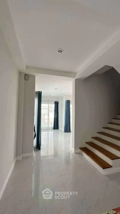 Spacious modern interior with elegant staircase and natural light