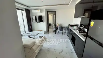 Modern living room with sleek kitchen and balcony access