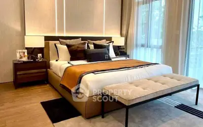 Luxurious bedroom with elegant decor and large windows for natural light.