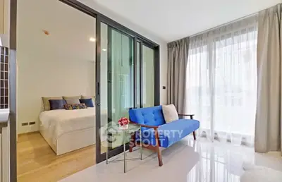 Modern apartment with glass partitioned bedroom and stylish living area