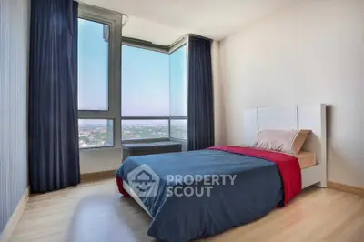 Modern bedroom with large windows offering stunning city views and minimalist decor.