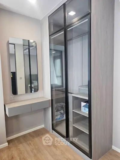 Modern bedroom with sleek mirrored wardrobe and stylish vanity unit