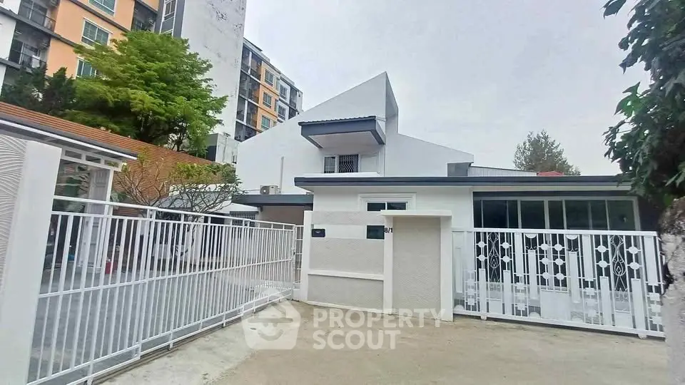 Modern residential building with gated entrance and contemporary design