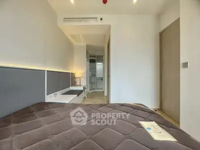 Modern bedroom with sleek design and cozy ambiance in a contemporary apartment.