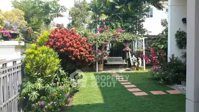Charming garden with lush greenery and vibrant flowers, perfect for relaxation and outdoor enjoyment.