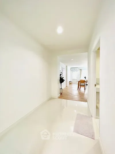 Bright hallway leading to a modern living area with elegant decor.