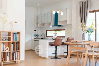 Modern open-plan kitchen and dining area with stylish decor and natural light.