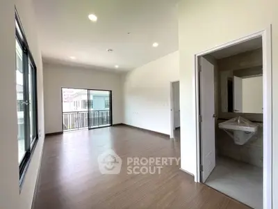 Spacious modern living room with balcony and sleek flooring