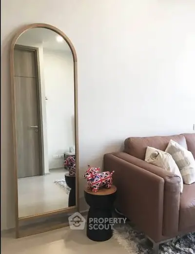 Stylish living room with modern decor and full-length mirror