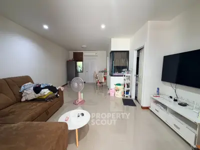 Spacious living room with modern decor and comfortable seating in a contemporary apartment.