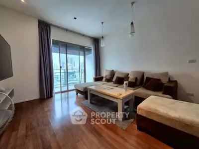 Spacious living room with modern decor and city view balcony