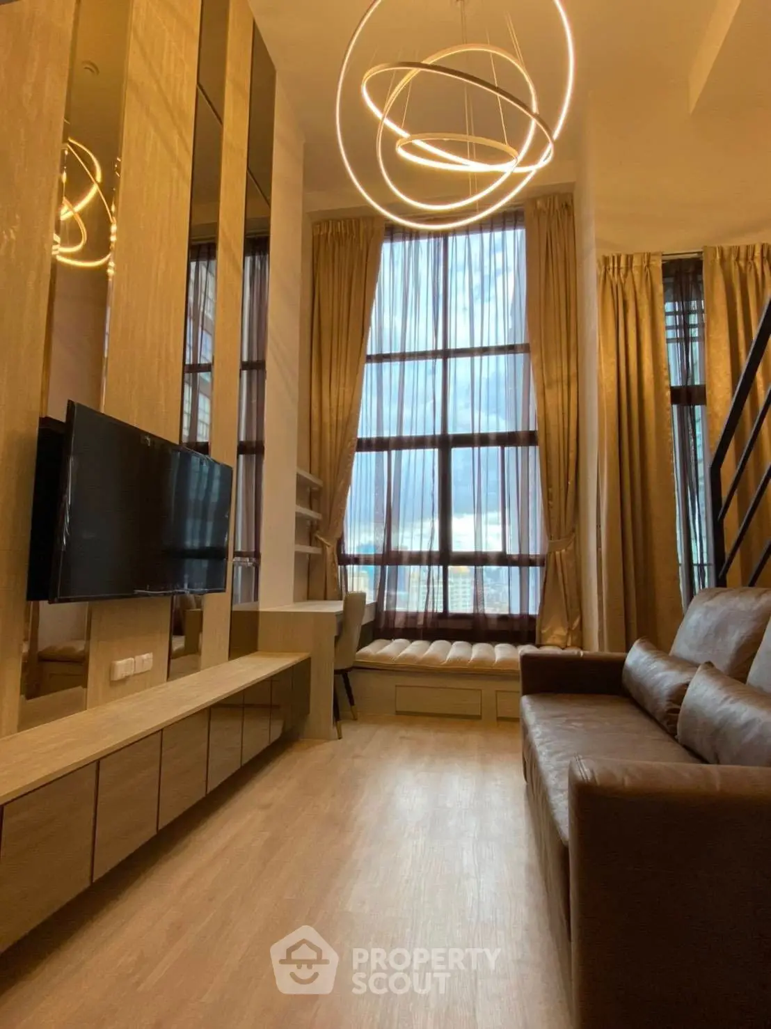 Luxurious high-ceiling living room with modern lighting and floor-to-ceiling windows.