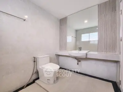 Spacious modern bathroom with sleek design and large mirror