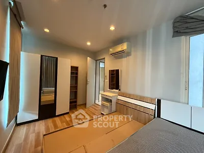Modern bedroom with wooden flooring and built-in air conditioning
