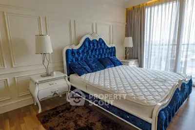 Luxurious bedroom with elegant blue velvet bed and classic decor