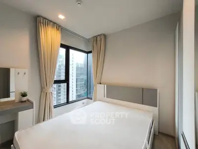 Modern bedroom with large windows and city view, featuring minimalist decor and natural light.