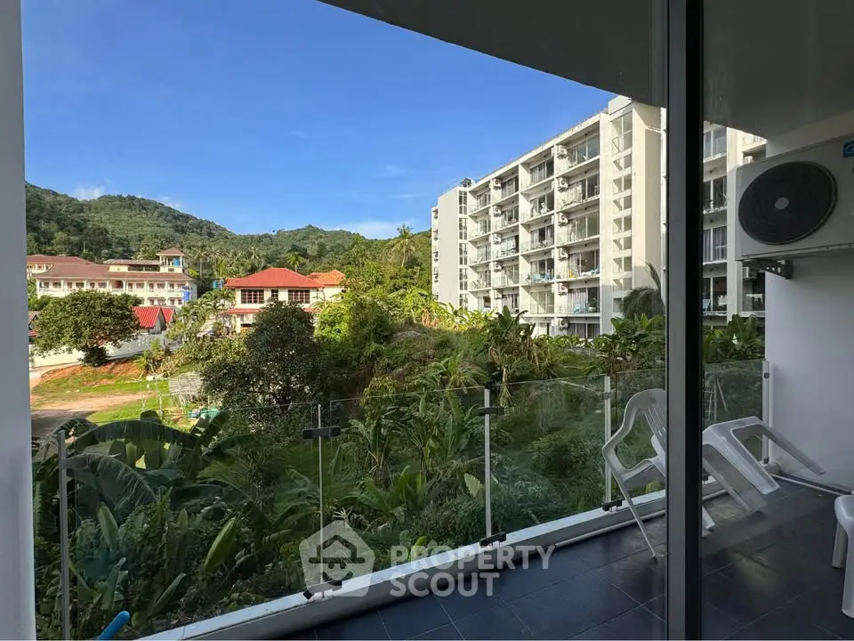 Stunning balcony view of lush greenery and modern buildings in a serene residential area.