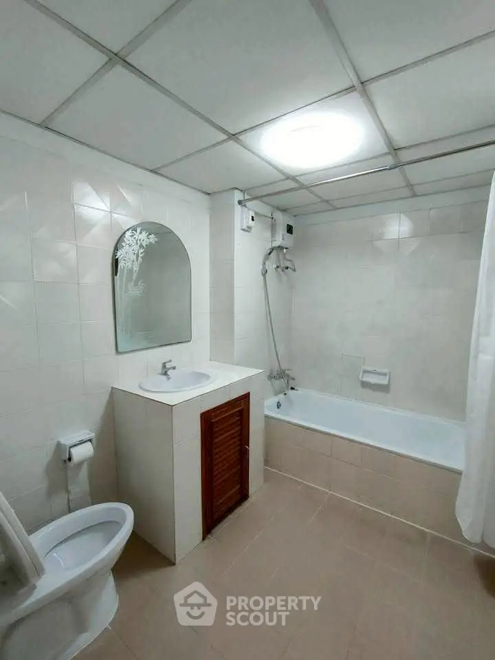 Spacious bathroom with bathtub and modern fixtures in a stylish real estate property.