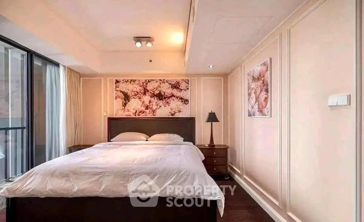 Elegant bedroom with floral decor and modern lighting in a cozy apartment.