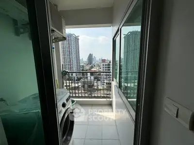Modern balcony with city view and laundry area in high-rise apartment