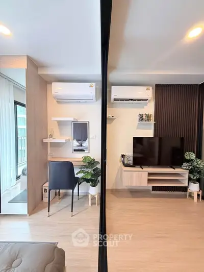 Modern living room with air conditioning, stylish decor, and natural light in a contemporary apartment.