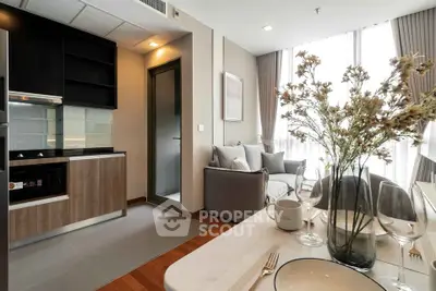 Modern open-plan kitchen and living area with stylish decor and natural light.