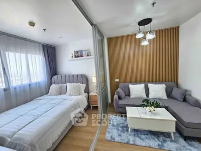 Modern studio apartment with cozy bedroom and stylish living area, featuring elegant decor and natural light.