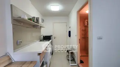Modern compact kitchen with sleek design and integrated appliances in a cozy apartment.