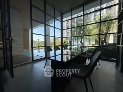 Modern glass-walled room with pool view in luxury apartment building