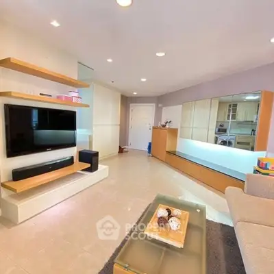 Spacious modern living room with sleek entertainment center and cozy seating area.