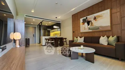 Modern living room with stylish decor and open layout, featuring elegant furniture and contemporary artwork.