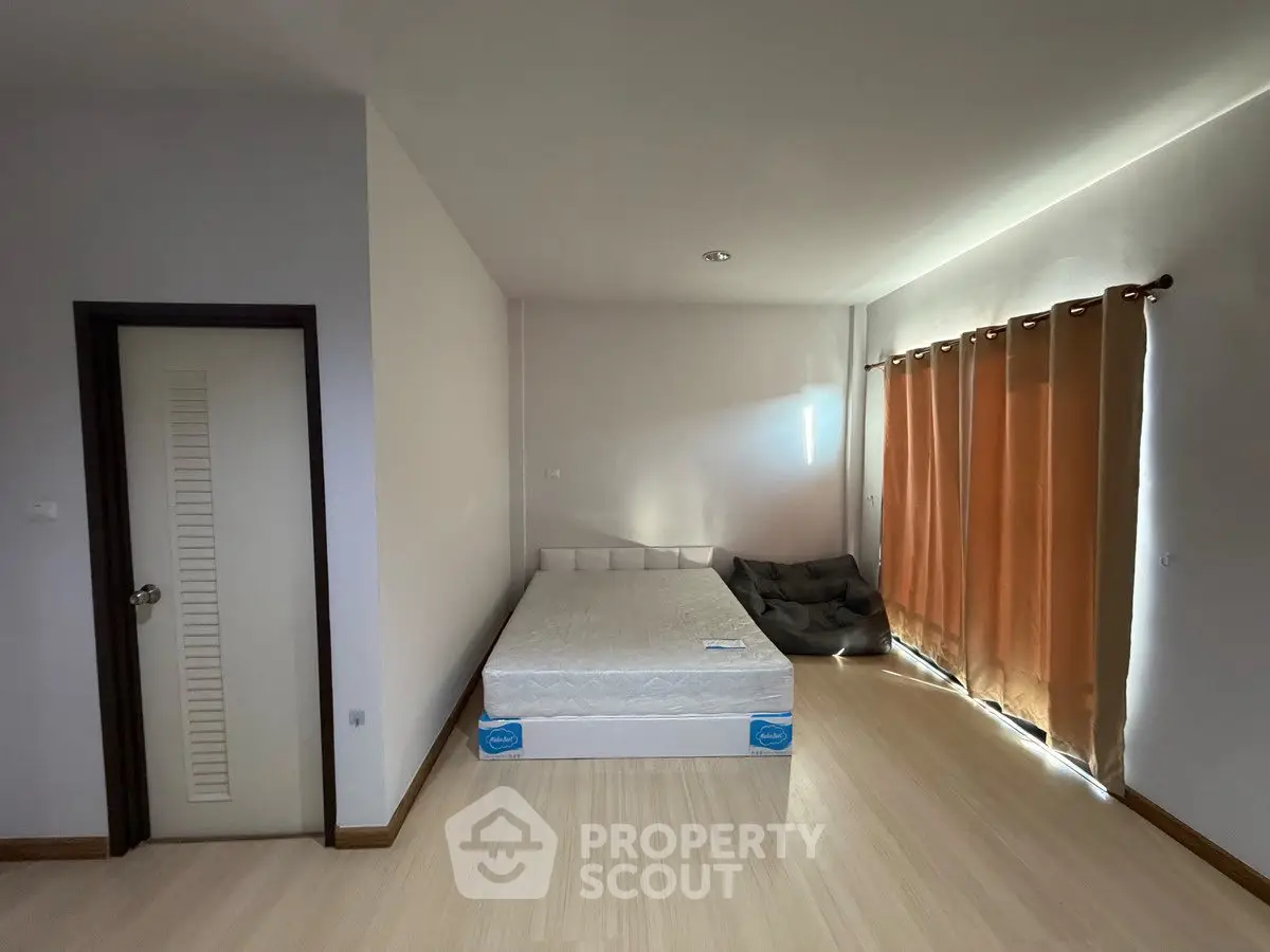 Spacious bedroom with minimalist design and natural light