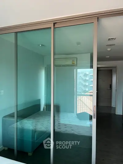 Modern apartment with glass sliding doors and cozy interior design