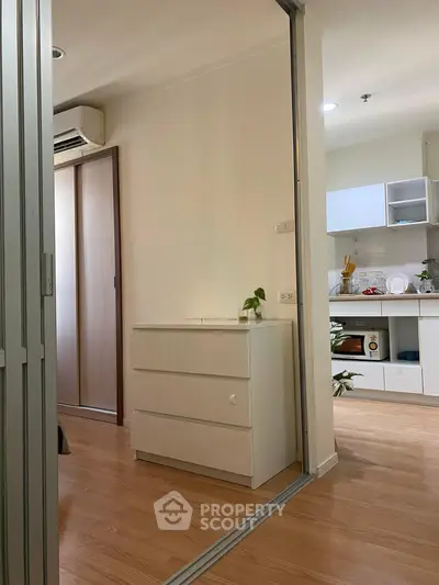 Modern apartment interior with open kitchen and sleek wooden flooring