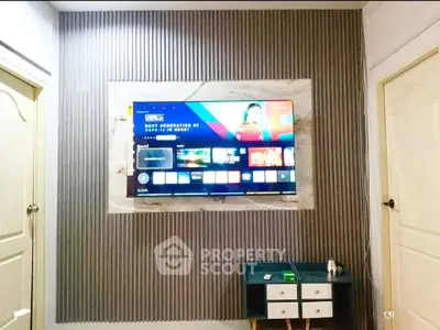 Modern living room with wall-mounted TV and stylish decor