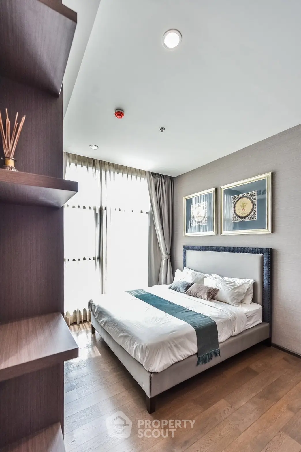 Modern bedroom with elegant decor and natural light in a stylish apartment.