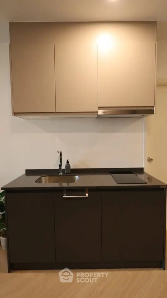 Modern kitchen with sleek cabinetry and integrated appliances in a contemporary apartment.