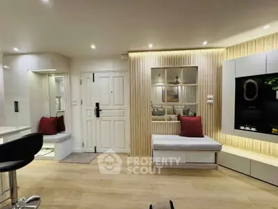 Modern living room with stylish decor and cozy seating area, featuring elegant lighting and contemporary design.