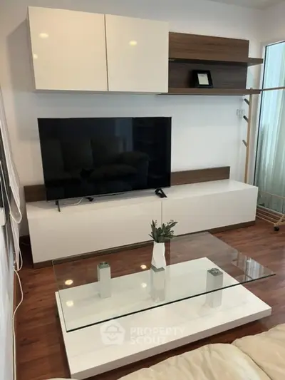 Modern living room with sleek TV unit and glass coffee table