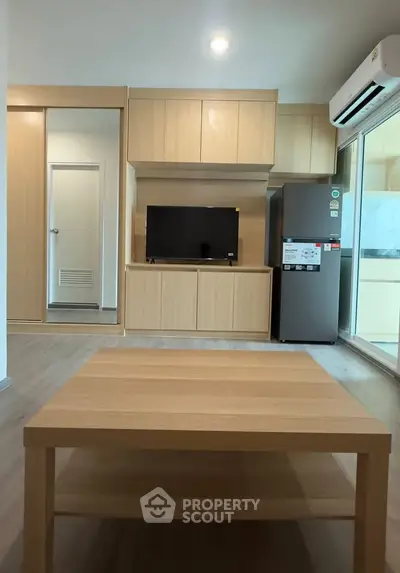 Modern living room with wooden furniture and sleek appliances in a stylish apartment.