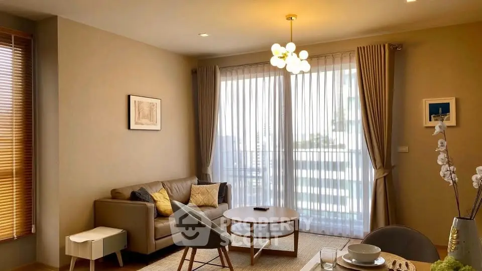 Elegant living room with modern furniture and large windows offering natural light.