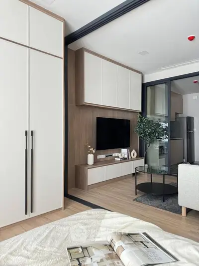 Modern living room with sleek furniture and open layout, featuring a stylish TV unit and cozy seating area.