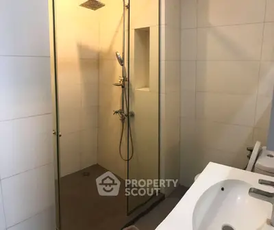 Modern bathroom with glass shower and sleek fixtures