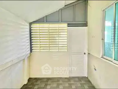 Bright enclosed balcony with modern design and large window