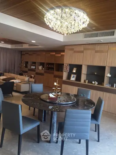 Luxurious living room with elegant chandelier and modern dining area