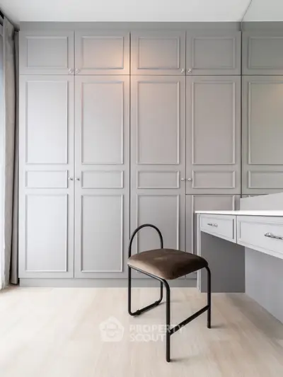 Elegant study area with built-in cabinets and modern chair