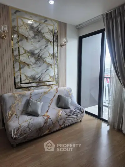 Stylish living room with marble accents and balcony access in modern apartment