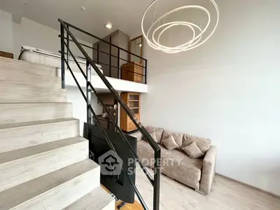 Modern loft apartment with stylish staircase and cozy living area