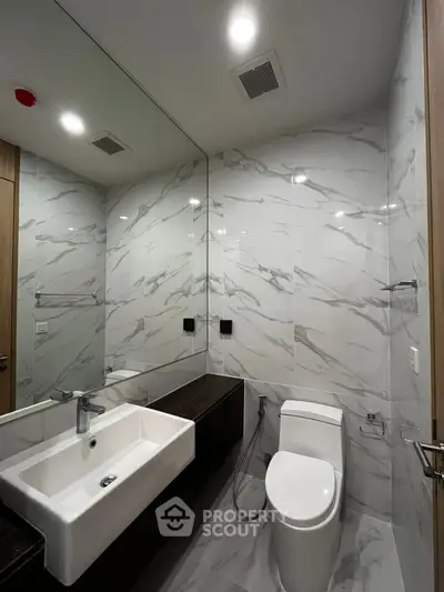 Modern bathroom with sleek marble tiles and contemporary fixtures